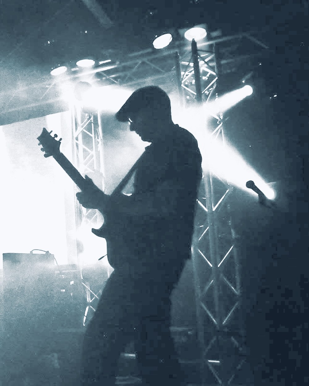 Playing guitar in silhouette against stage lights, live with Zero Degree at the Wave-Gotik-Treffen in Leipzig, 2011